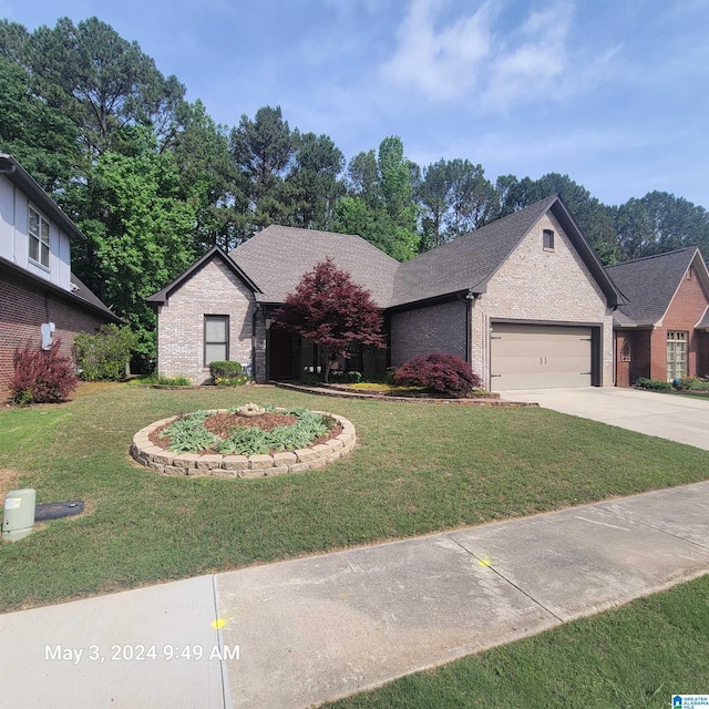 view of front of property with a garage, brick siding, concrete driveway, and a front yard