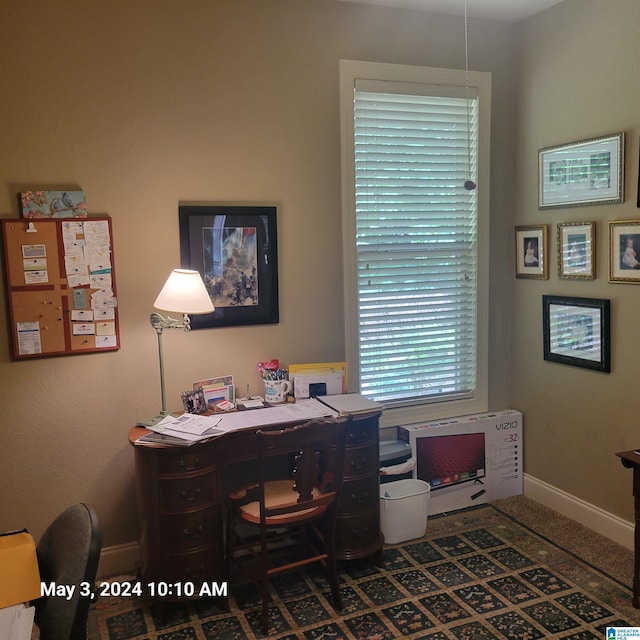 office space featuring heating unit and baseboards