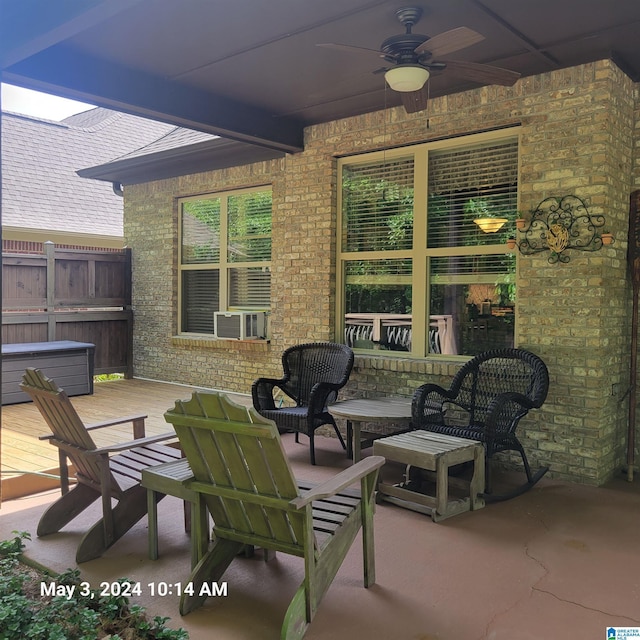 view of patio / terrace with outdoor lounge area, a hot tub, a ceiling fan, fence, and a wooden deck