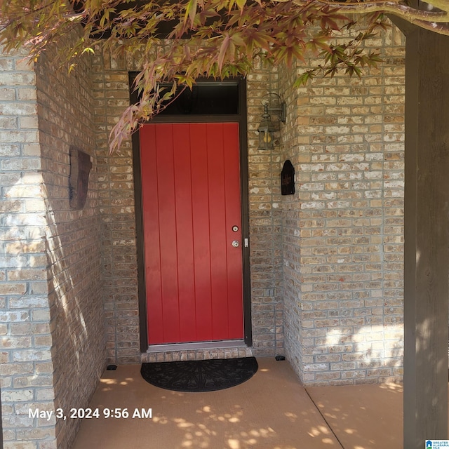 property entrance with brick siding