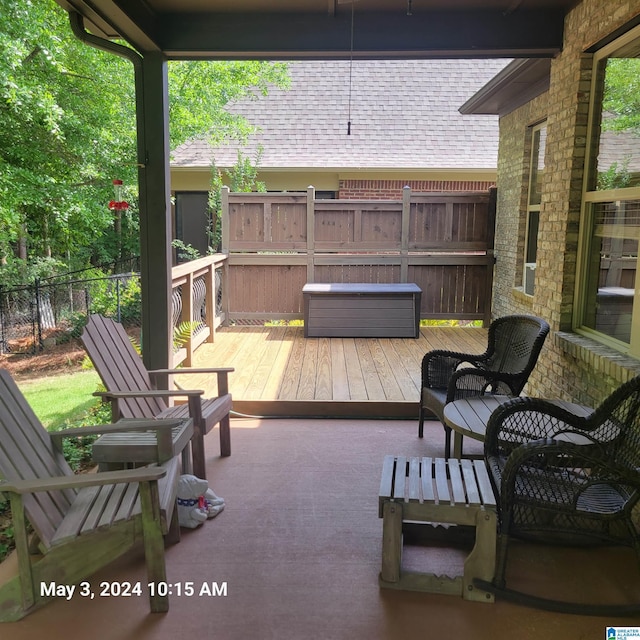 view of patio / terrace with a jacuzzi, fence, and a deck