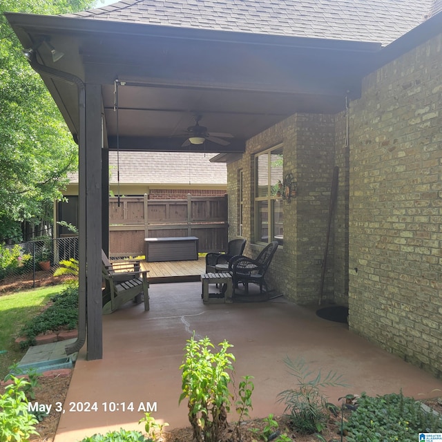 view of patio / terrace featuring ceiling fan, a deck, and fence