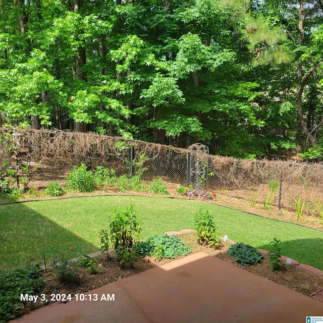 view of yard with fence and a patio