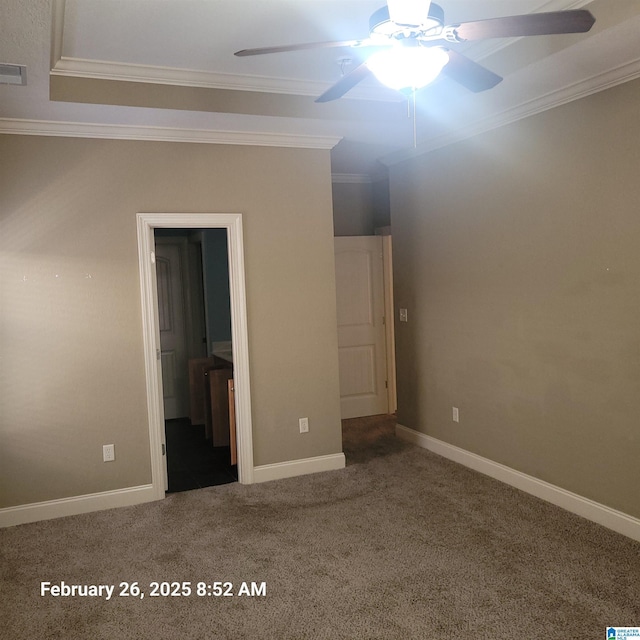 unfurnished bedroom featuring ornamental molding, a ceiling fan, carpet flooring, ensuite bath, and baseboards