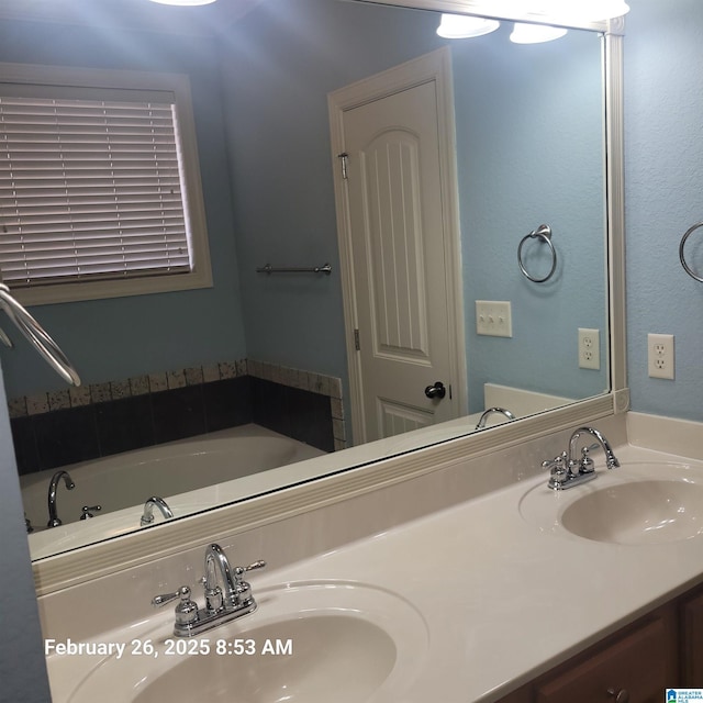 full bathroom with a garden tub, a sink, and double vanity