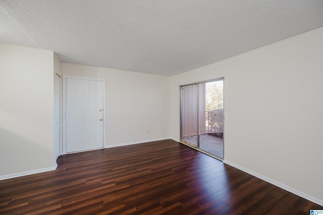 unfurnished room featuring dark hardwood / wood-style floors and a textured ceiling