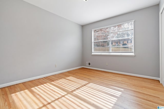 unfurnished room with hardwood / wood-style flooring