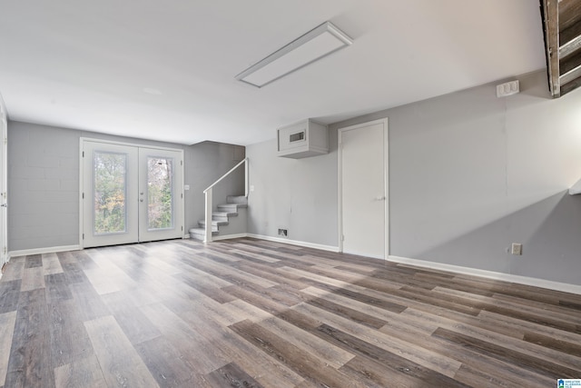 basement featuring hardwood / wood-style floors and french doors