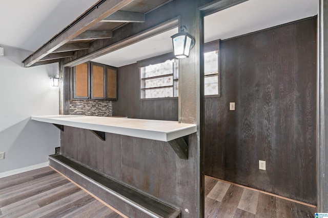 bar featuring tasteful backsplash and dark hardwood / wood-style floors