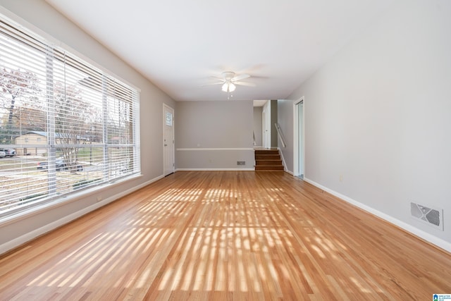 empty room featuring ceiling fan and light hardwood / wood-style flooring