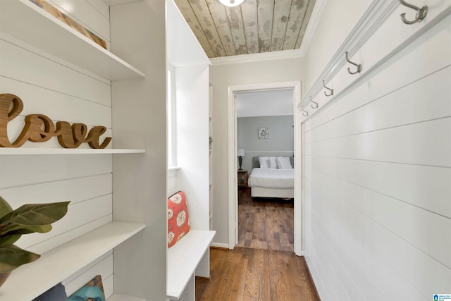 mudroom with dark hardwood / wood-style floors, wood ceiling, and crown molding