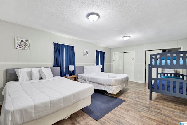 bedroom featuring hardwood / wood-style floors and a textured ceiling