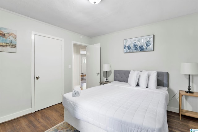 bedroom featuring dark wood-type flooring and ornamental molding