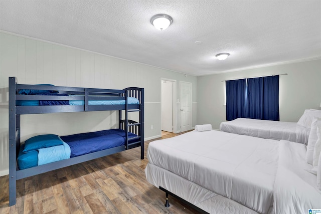 bedroom with wood-type flooring and a textured ceiling