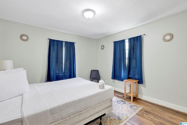 bedroom with wood-type flooring