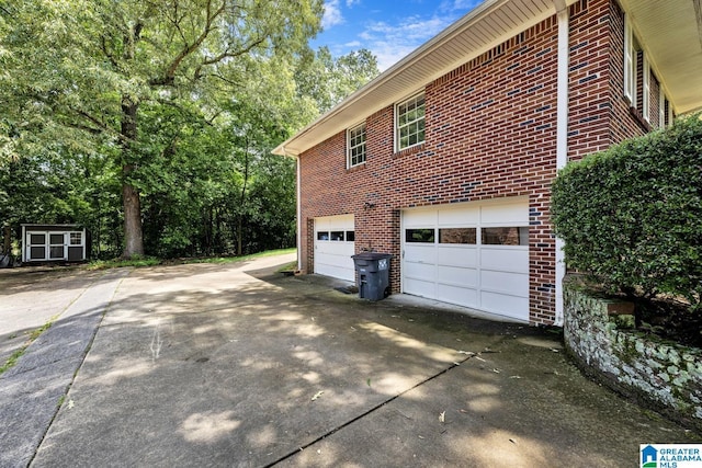 view of property exterior featuring a garage and a storage shed