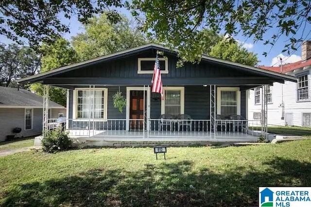 bungalow-style house with a front lawn and covered porch