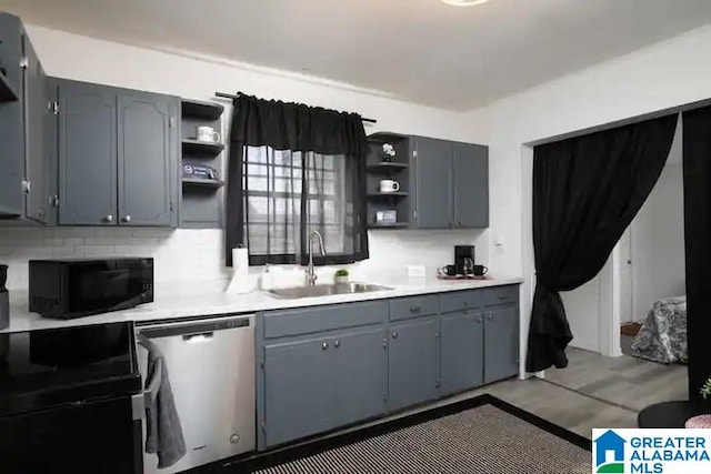 kitchen featuring tasteful backsplash, gray cabinetry, sink, dishwasher, and light hardwood / wood-style floors