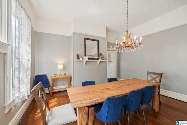 dining space with dark hardwood / wood-style flooring, plenty of natural light, and a chandelier