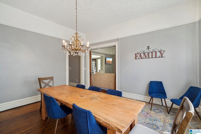 dining space with a textured ceiling, a chandelier, and dark hardwood / wood-style floors