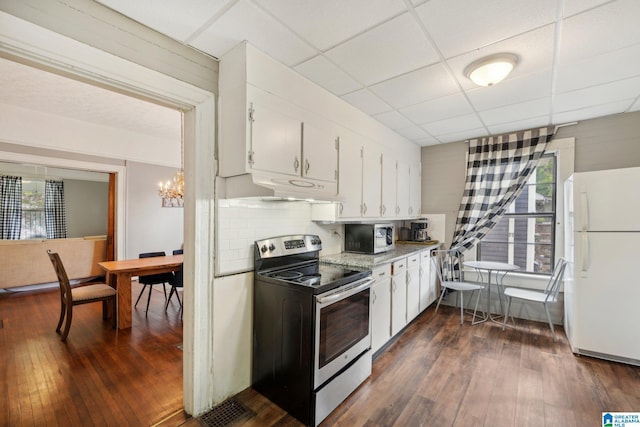 kitchen with a paneled ceiling, white cabinetry, dark wood-type flooring, and stainless steel appliances