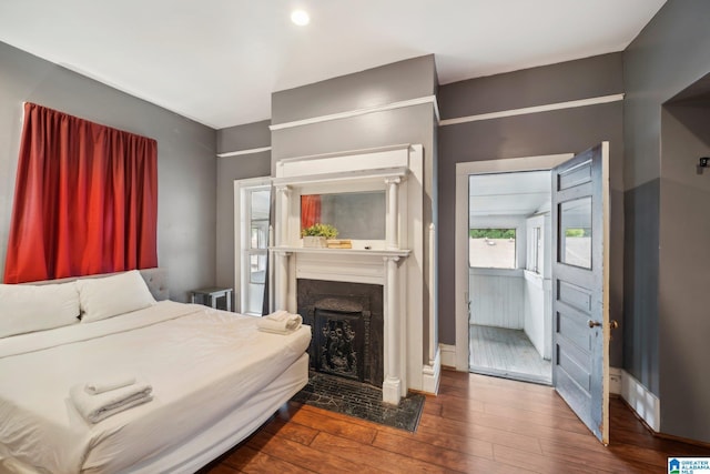 bedroom with dark hardwood / wood-style floors