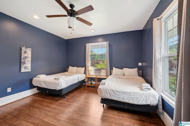 bedroom with ceiling fan and wood-type flooring