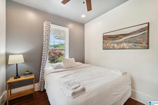 bedroom with ceiling fan and dark hardwood / wood-style flooring