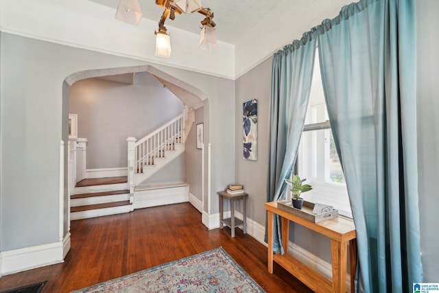 foyer featuring a textured ceiling and dark hardwood / wood-style floors