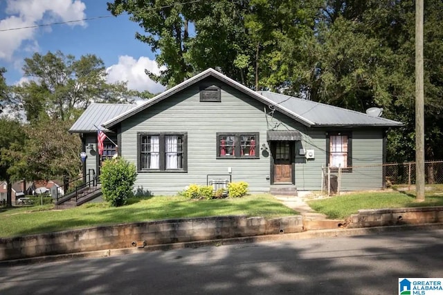 bungalow-style house with a front lawn