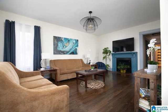 living room with dark wood-type flooring and a chandelier