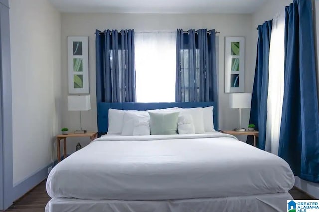 bedroom featuring wood-type flooring and multiple windows