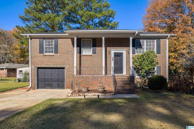 raised ranch featuring a front lawn and a garage