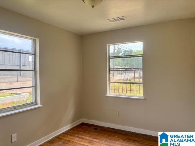 spare room with dark hardwood / wood-style flooring