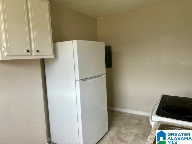 kitchen featuring white cabinets and white appliances