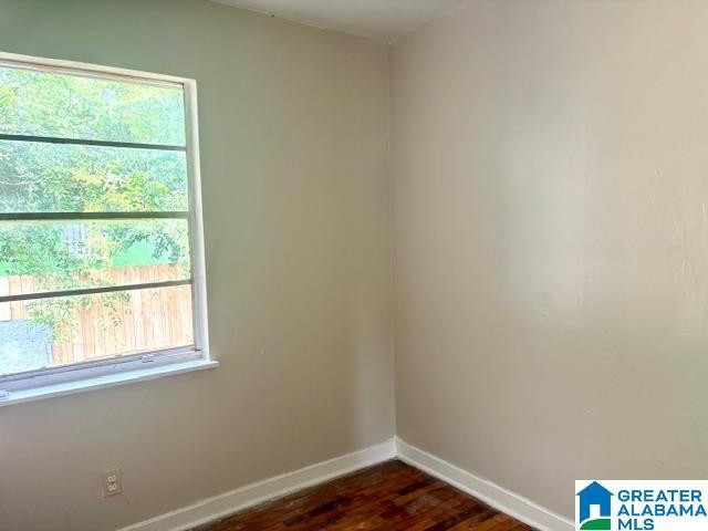 spare room with dark wood-type flooring