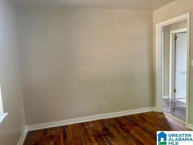 empty room with dark hardwood / wood-style flooring