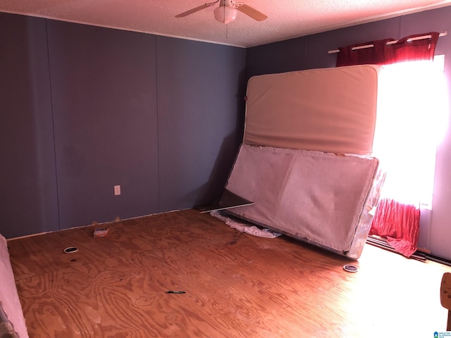 unfurnished bedroom featuring ceiling fan and a textured ceiling