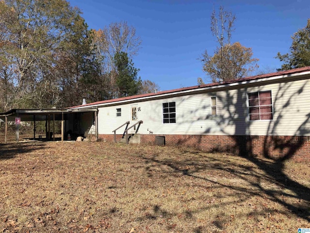 back of house featuring a carport