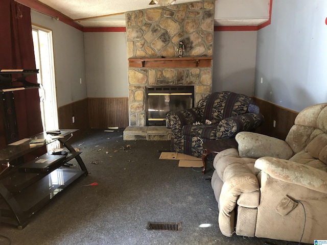 living room with wooden walls, a fireplace, carpet floors, and lofted ceiling