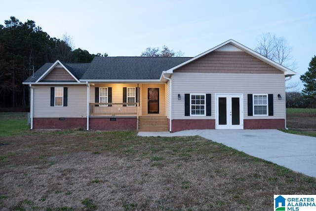 ranch-style home featuring covered porch and french doors