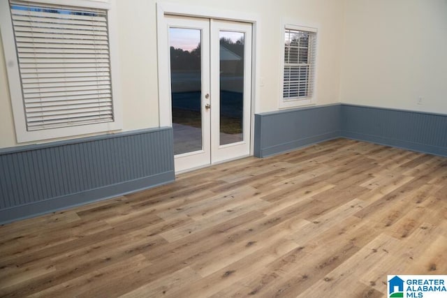 spare room with wood-type flooring and french doors