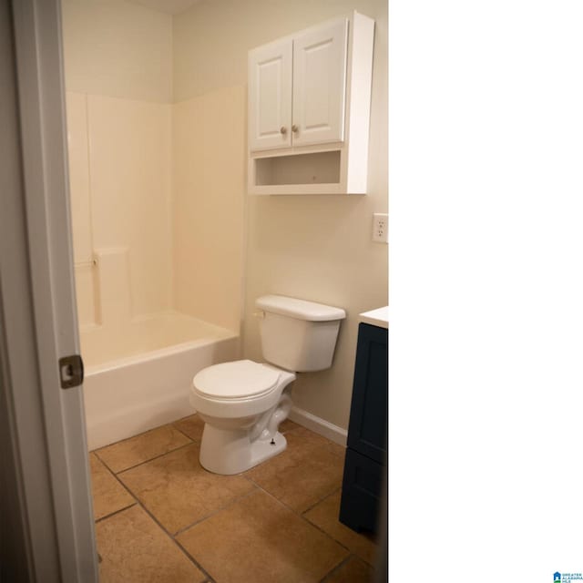 bathroom featuring tile patterned flooring, vanity, and toilet