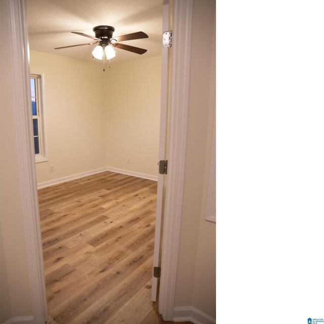 spare room featuring ceiling fan and light hardwood / wood-style floors