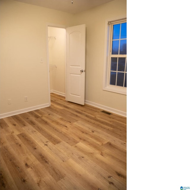 empty room with light hardwood / wood-style flooring