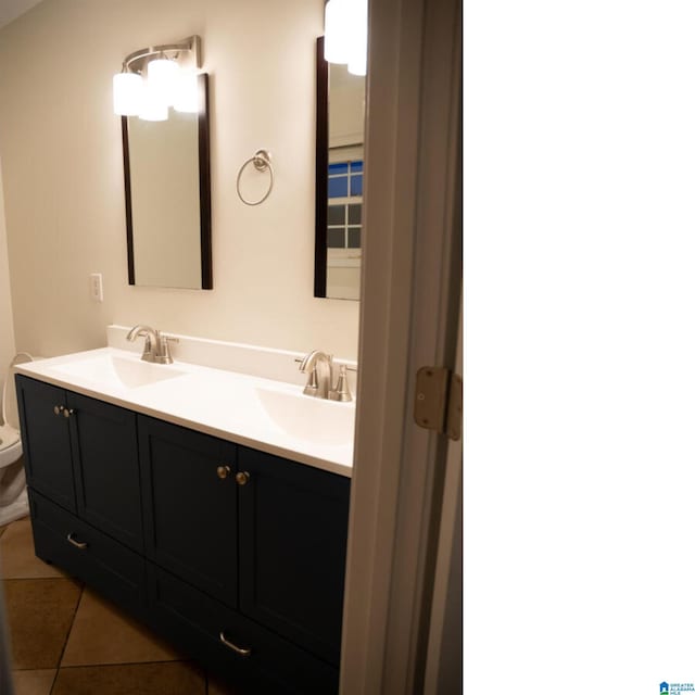 bathroom featuring tile patterned flooring, vanity, and toilet