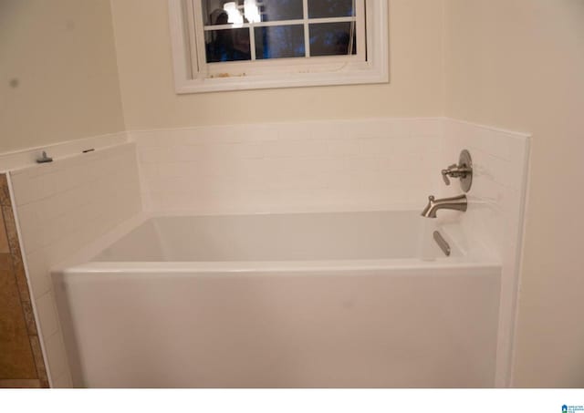 bathroom featuring a washtub