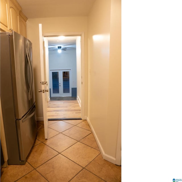 hallway with light tile patterned floors and french doors