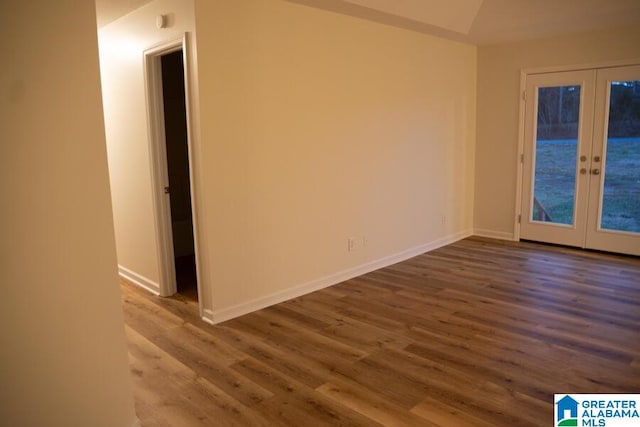 unfurnished room with hardwood / wood-style floors and french doors