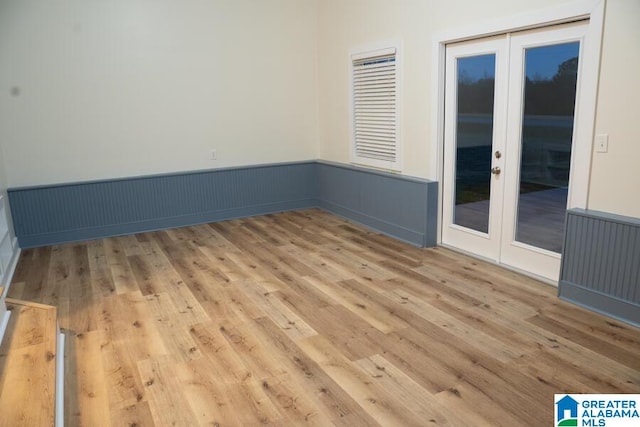 empty room featuring light hardwood / wood-style flooring and french doors